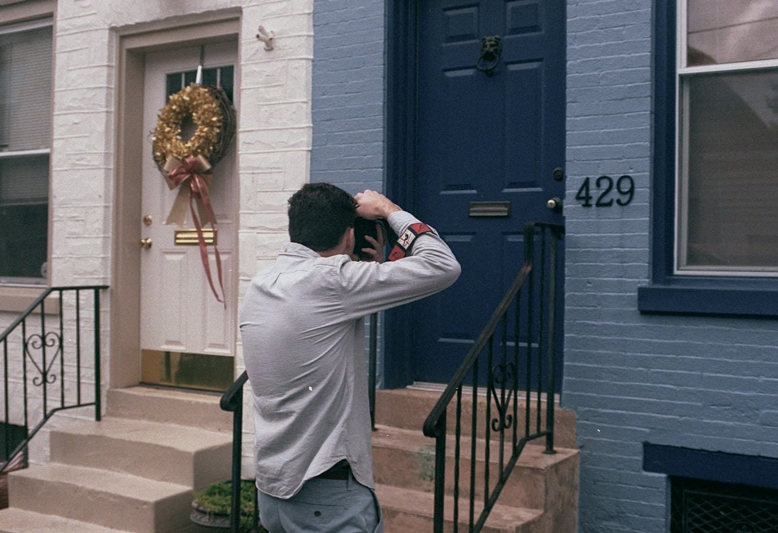 Inspector photographing a front door